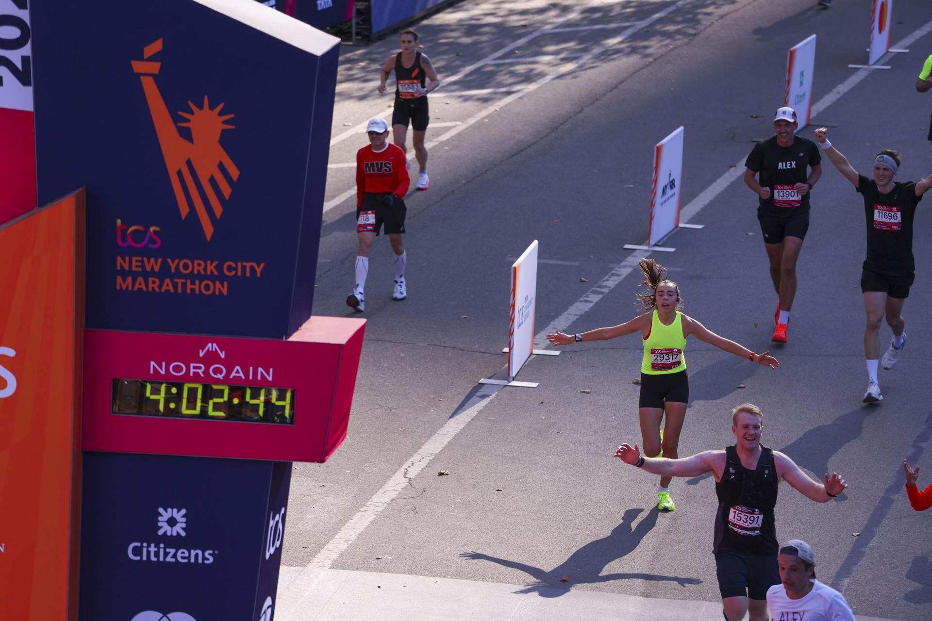 Corredores cruzan la linea final del Maratón de Nueva York. EFE/SARAH YENESEL